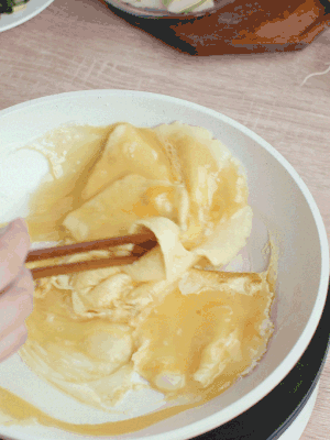 油6成熱時(shí)，下雞蛋液，邊緣凝固時(shí)翻拌成塊狀。